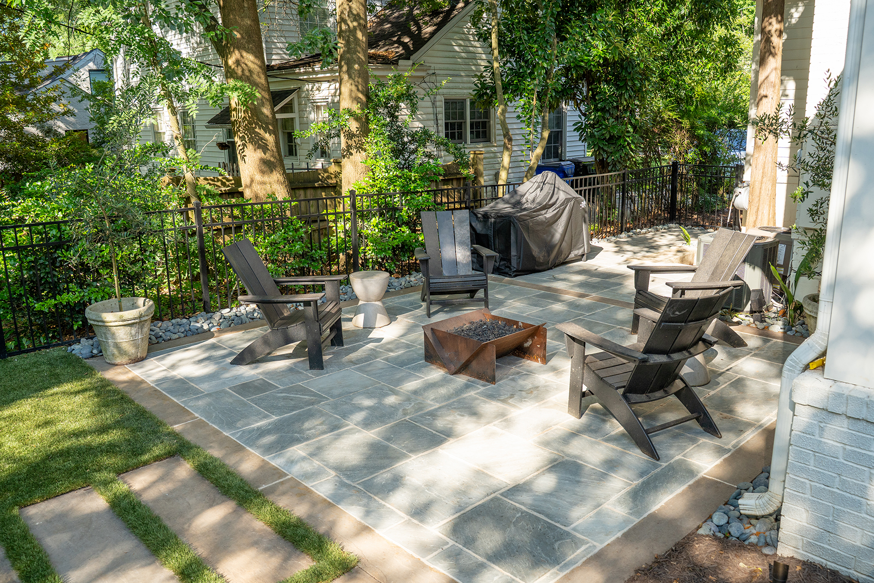 Back patio with firepit in multi-phase modern landscape design Greenville SC project