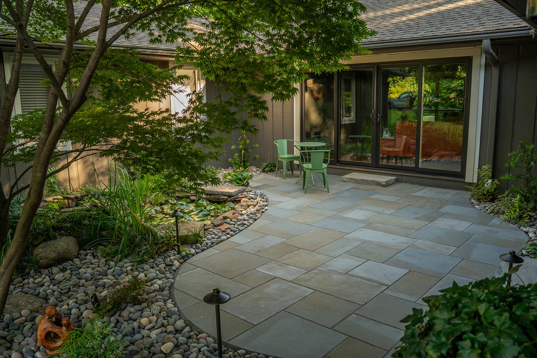 Refreshed courtyard patio with outdoor seating area and landscaped borders in Greenville, SC