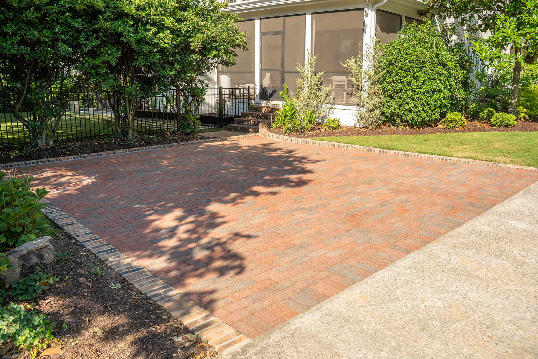 Driveway integration in multi-phase modern landscape design Greenville SC project