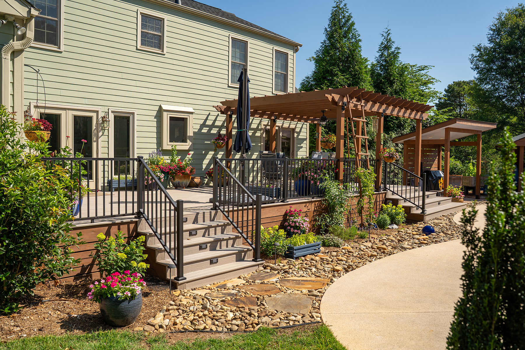 Covered outdoor kitchen and pergola built as part of an outdoor living renovation in Greenville, SC