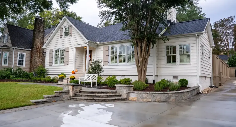 Hardscaping in Greenville, SC featuring custom stone retaining wall and integrated steps at a home entrance